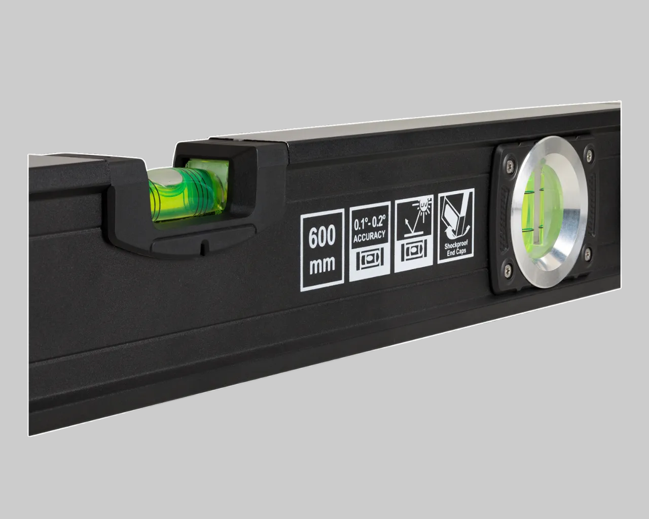 Black dgital level with green laser pointer on a dark background